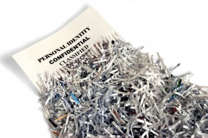 A document with confidential information being shredded